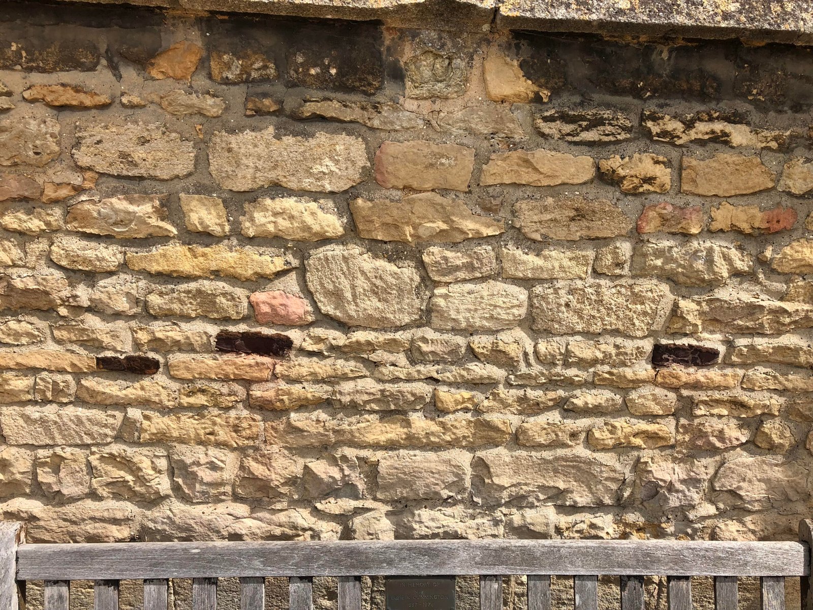 A photograph of a wall on Castor Church which show Roman bricks as part of the construction.