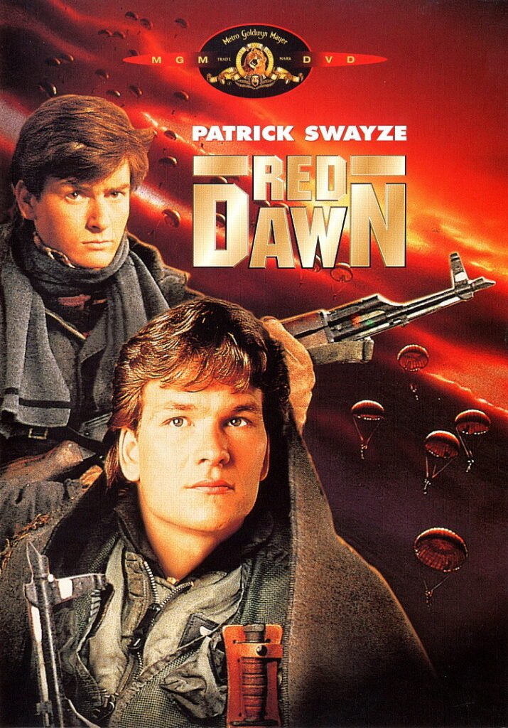 Poster for the 1984 film Red Dawn, featuring Patrick Swayze in military gear with a determined expression. Behind him, a stylised red sky is filled with descending parachutes and a flying Soviet helicopter gunship, evoking an invasion. The film’s title appears in bold metallic letters, and the MGM logo tops the image. The overall aesthetic is patriotic and dramatic, conjuring Cold War paranoia and resistance fantasy.