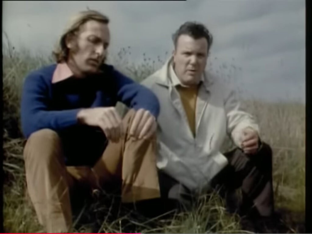 Jack Walker sitting outside next to John Pilger.